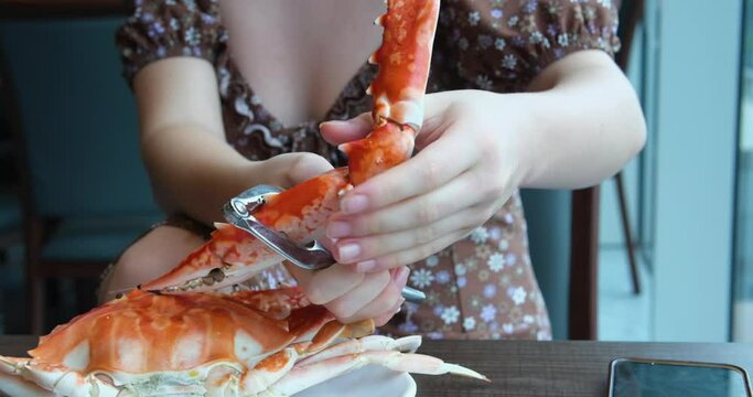 video of a girl cutting crab at a buffet table