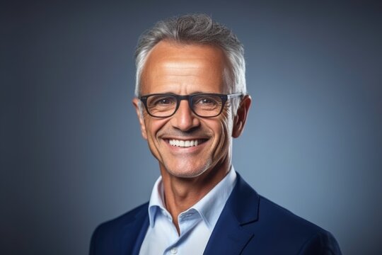 A professional-looking individual with glasses and suit smiling directly at the camera, great for business or finance related content