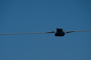 Power line tensioner in the middle of a span.