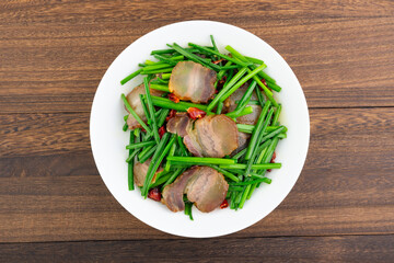 A dish of fried leek moss with bacon