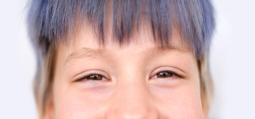 close up part child face, boy 8 years old laughing, human eye looking directly, vision examination,...
