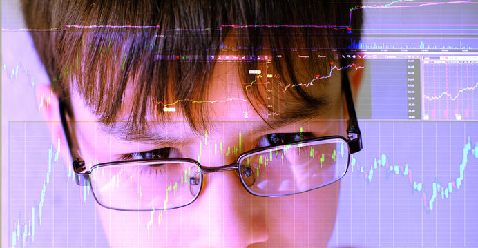 Intelligent 12-year-old child, boy wearing glasses intently studies stock market charts on computer screen, showcasing potential young financial traders, future of finance, financial literacy