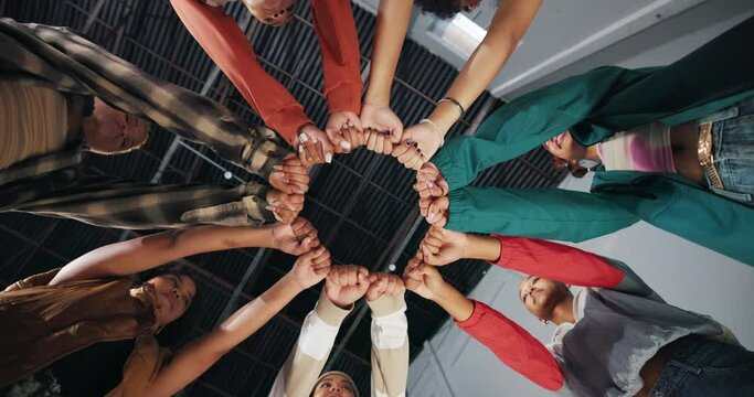 People, teamwork and fist bump in circle for support with trust, partnership and collaboration from below. Friends, hands and emoji for solidarity with team building, goals and power with low angle