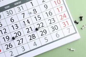Timetable. Calendar and drawing pins on green background, top view
