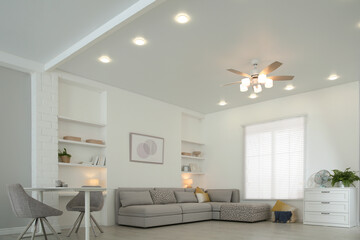 Comfortable furniture, ceiling fan and accessories in stylish living room