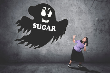 Young girl runs against sugar monster