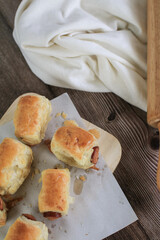 Sausage rolls on wooden table. Puff pastry eat with coffee or tea. Traditional British food concept. Food photography
