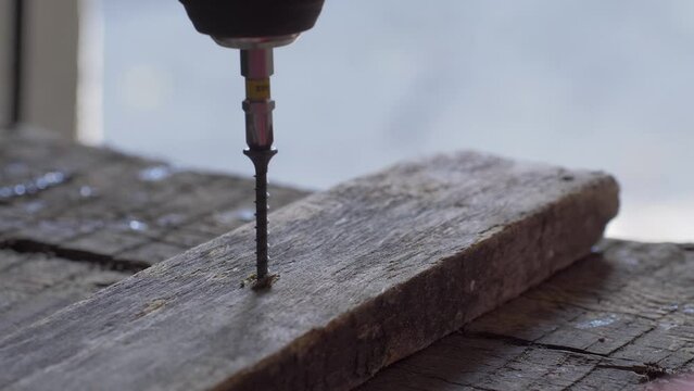 Electric screwdriver is handy for various DIY projects and construction tasks. It helps to drive self-tapping screw in wooden board with minimal effort. Screw creates its own thread as it enters wood