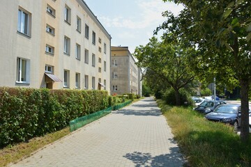 A sidewalk and an old apartment blocks
