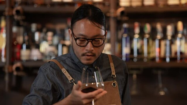 Night club concept of 4k Resolution. The bartender is confidently pouring wine into glasses. A group of specialized clubs that sell alcoholic beverages.