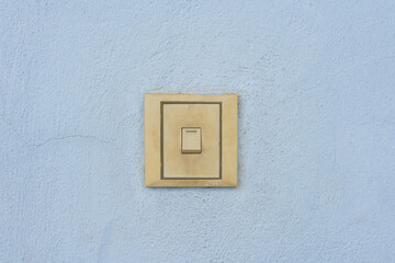 Wall-mounted light switch with white plastic cover