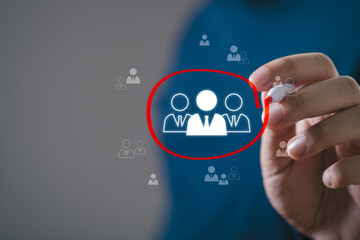 Human Resource Management, Hand holding pen and choose red circle focus to manager icon which is among staff icons for human development recruitment leadership and customer target group concept.