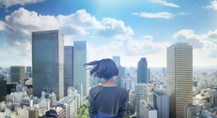日本の街・都市・朝日を受けたオフィスビル群を前に佇み風を受けて髪をなびかせる会社員の女性の出勤　就職・ビジネス・はじまり・決意・目標・挑戦のイメージ