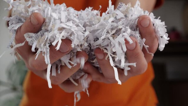 Shredded paper office documents in worker hands