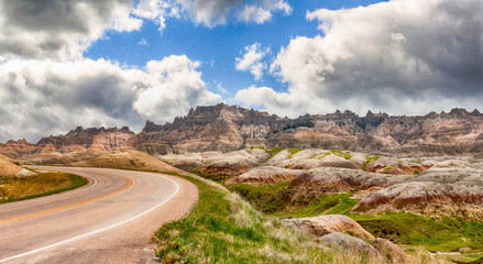 Rural highway in the Badlands clear blue sky mountains