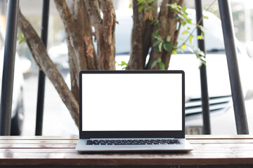 Laptop computer on desk at office or co-working space, Laptop with white blank on screen and blurred background , working space concept.