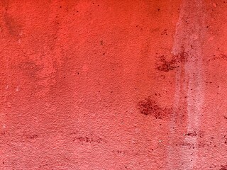 a photography of a red wall with a fire hydrant in the corner.