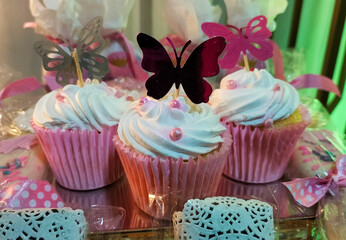 Decorative cakes with butterfly theme at a party table