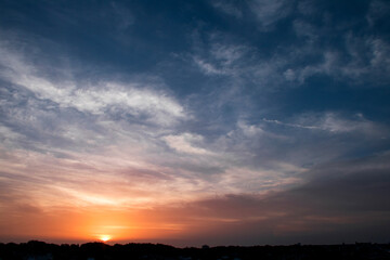 Stunning Sunset Over Horizon with Dramatic Sky