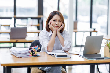 Happy asian business woman entrepreneur in office using laptop at work, smiling professional female company executive wearing suit working on computer at workplace.