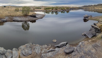 Dry farmland and Butchers Creek reservoir, Alexandra, Otago, New Zealand.