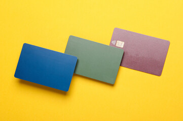 Plastic Bank cards on yellow background
