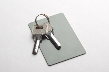 Credit card with keys on gray background