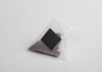 Pyramid of tea bag on gray background