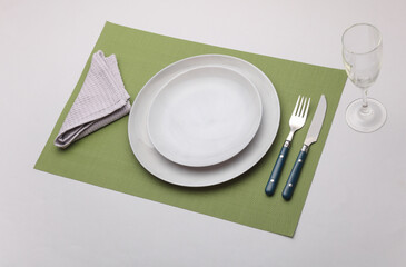 Set of dishes and cutlery for table setting on white background