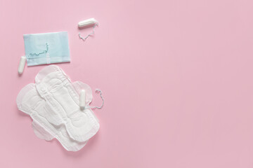 Menstrual pads with tampons on pink background
