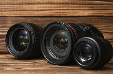 Set of Professional photographic or videographic lenses on a wooden background. Photographer's...