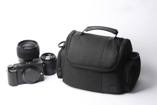 Equipment of a professional photographer. Photo bag with camera and lens on white background