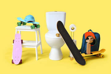 Toilet bowl with paper rolls and skateboards on yellow background