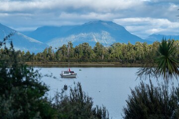 Boat on Lake and mountains in Te Anau, Fiordland, New Zealand.