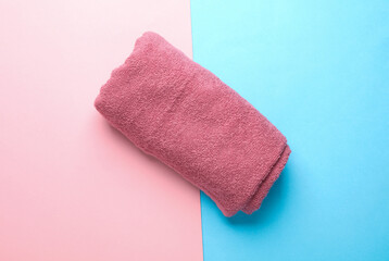 Roll of towel on blue pink background. Top view