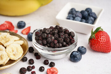 Tasty freeze-dried blueberries on white background