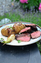 closeup grilled beef meat with vegetables and baked potatoe
