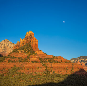desert sandstone cliff at sunset with blue sky and moon