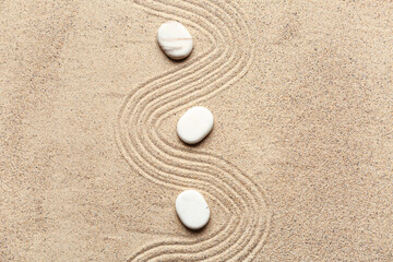 White stones on sand with lines. Zen concept