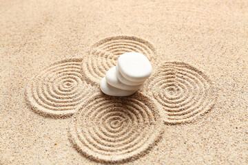 White spa stones on sand background