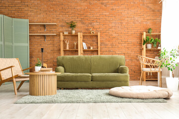 Interior of stylish living room with green sofa and wooden furniture