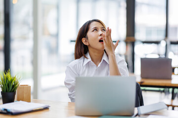 Fototapeta premium asian woman work at laptop thinking of problem solution, thoughtful female employee pondering considering idea looking at computer screen making decision 