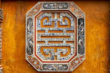 Detail Of Ceramic Mosaic On The Wall Of A Palace In Hue Imperial Citadel. Hue Imperial Citadel, A UNESCO Cultural Heritage Is A Major Tourist Destination In Vietnam.
