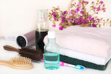 toothbrush, mouthwash health care for oral cavity with herbal shampoo, hair dryer arrangement flat lay style on background white