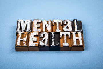 MENTAL HEALTH. Wooden alphabet letter blocks on blue textured background
