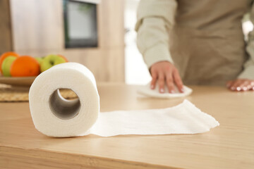 Roll of paper towels on table in kitchen, closeup