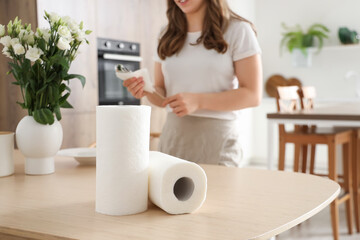 Rolls of paper towels on table in kitchen, closeup