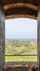 Amazing landscape of the vineyards of Langhe in Piemonte through a window. The wine route. An...