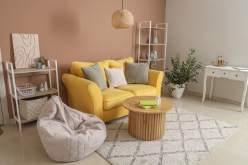 Interior of stylish living room with yellow sofa and wooden coffee table near beige wall