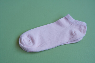 Pink socks on a green background. Women's socks.